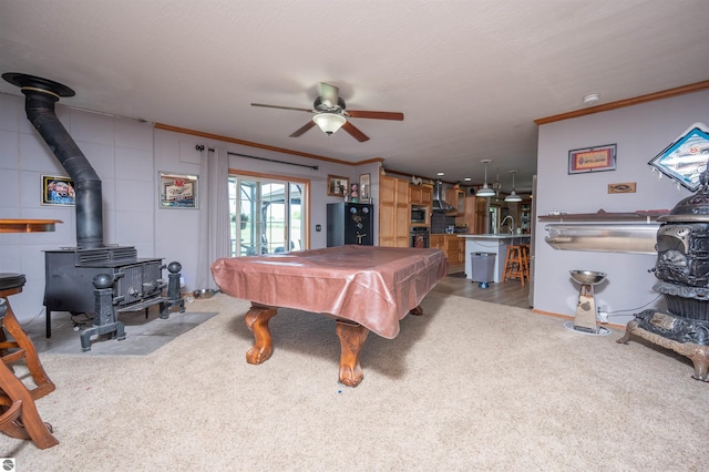 playroom with carpet flooring, a wood stove, crown molding, and billiards