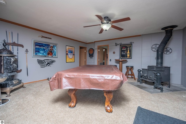 game room with ceiling fan, a wood stove, carpet floors, and billiards