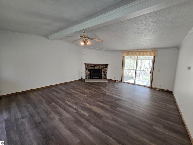 unfurnished living room featuring a fireplace, ceiling fan, beam ceiling, dark wood-type flooring, and a textured ceiling