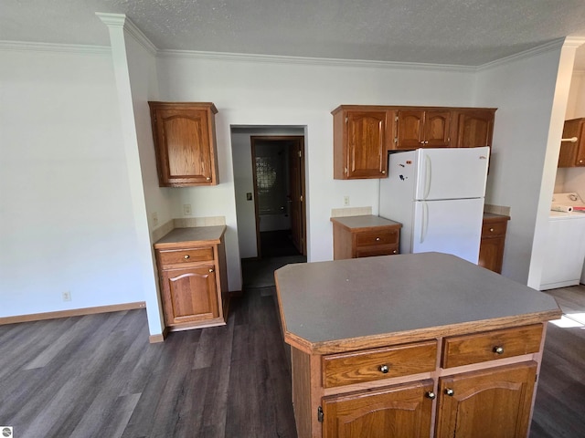 kitchen featuring ornamental molding, white fridge, and dark hardwood / wood-style floors