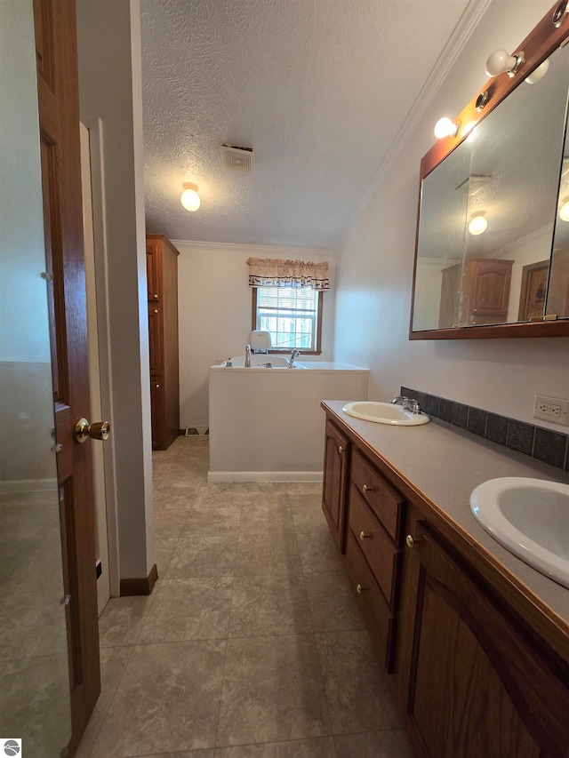 bathroom featuring double sink vanity, tile flooring, ornamental molding, a bath, and a textured ceiling