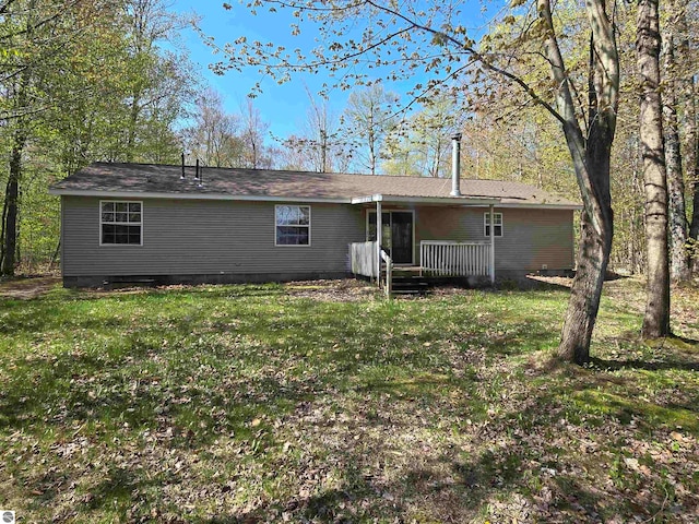 rear view of property with a lawn