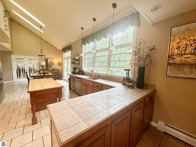 kitchen featuring kitchen peninsula, tile counters, stainless steel dishwasher, and a baseboard heating unit