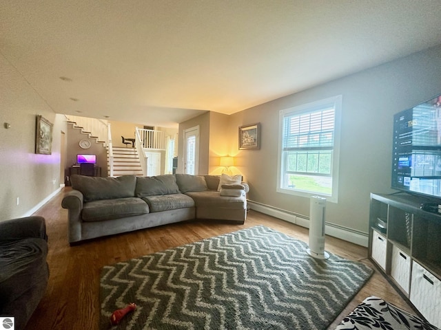 living room featuring hardwood / wood-style floors and a baseboard heating unit