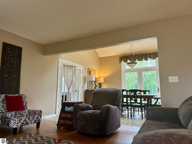 living room featuring light hardwood / wood-style flooring and an inviting chandelier