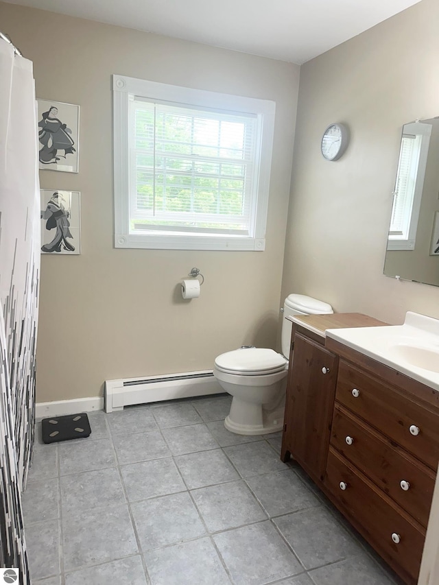 bathroom with tile patterned floors, vanity, toilet, and a baseboard heating unit