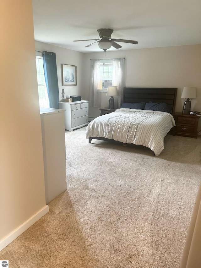 bedroom featuring ceiling fan, cooling unit, and light carpet