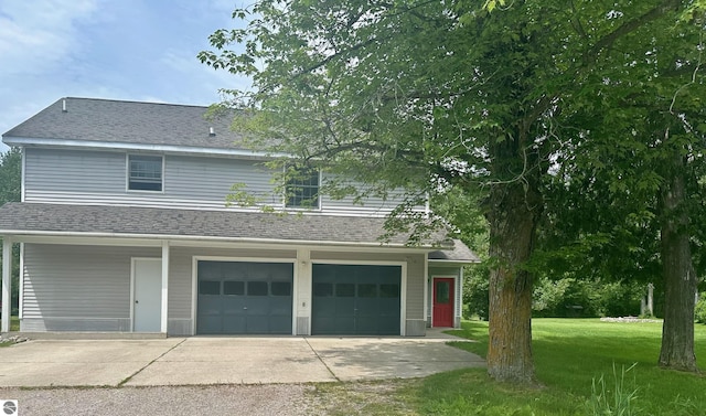 view of front of house featuring a garage and a front lawn