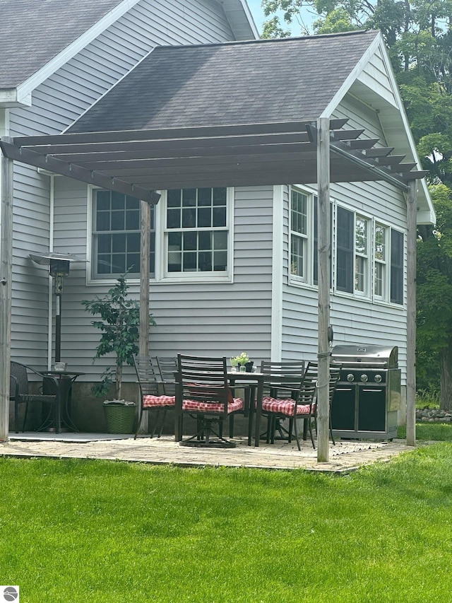 back of house featuring a pergola, a patio area, and a lawn