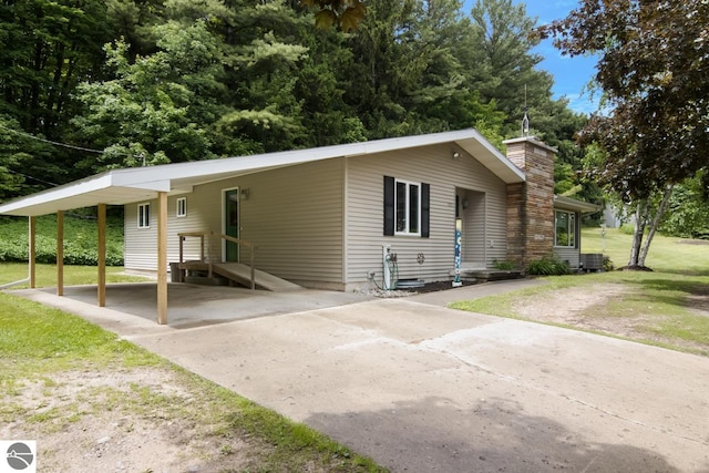 single story home with a carport and a front yard