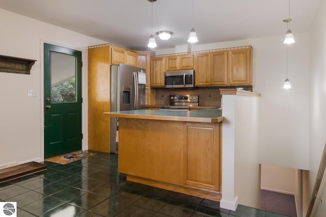 kitchen featuring decorative light fixtures, kitchen peninsula, appliances with stainless steel finishes, and tasteful backsplash