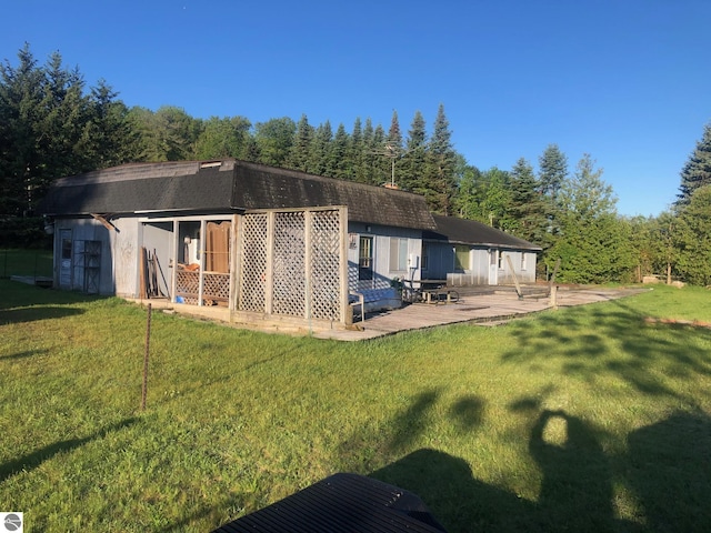 4472 Crescent Beach Rd, Onekama, MI 49675 - back of house featuring a forest view and a lawn