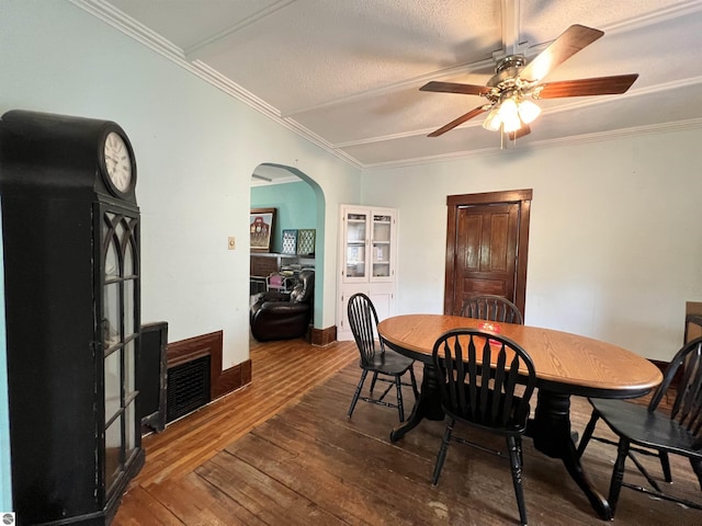 dining area featuring ceiling fan, dark hardwood / wood-style floors, ornamental molding, and a textured ceiling