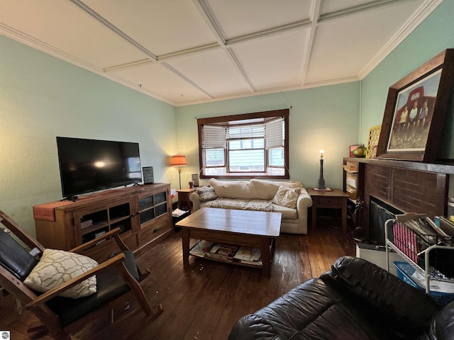 living room featuring a brick fireplace, dark hardwood / wood-style floors, ornamental molding, and coffered ceiling