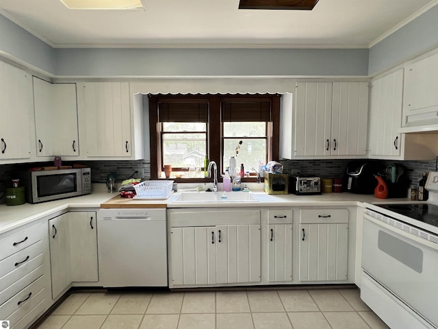 kitchen featuring decorative backsplash, light tile patterned floors, white appliances, and sink