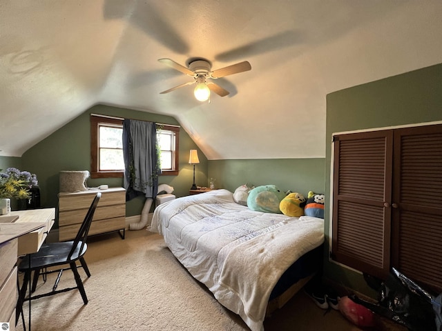 bedroom featuring ceiling fan, light carpet, and vaulted ceiling