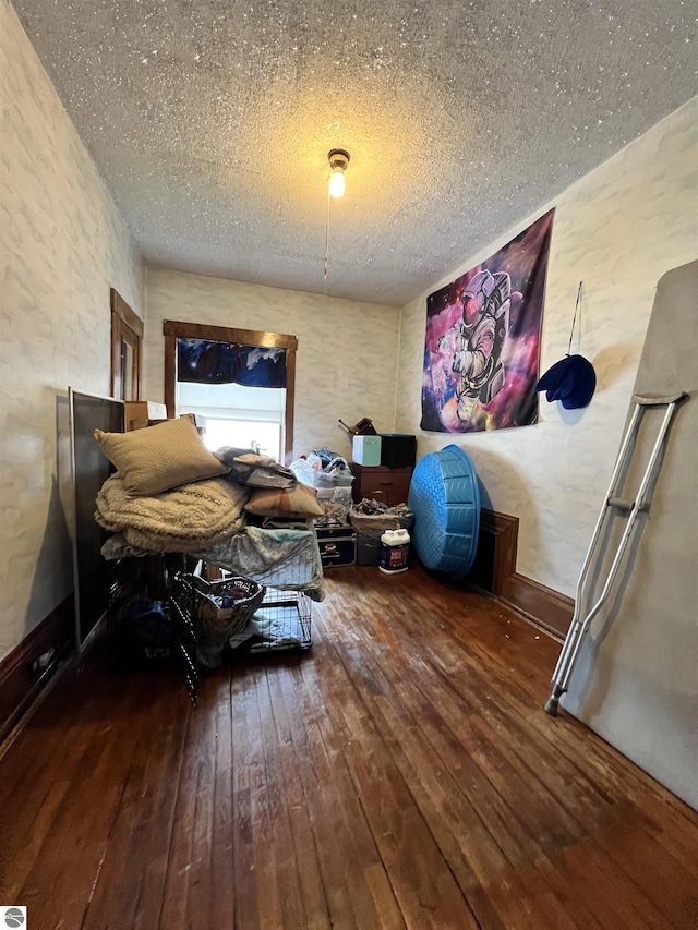 interior space featuring a textured ceiling and dark wood-type flooring