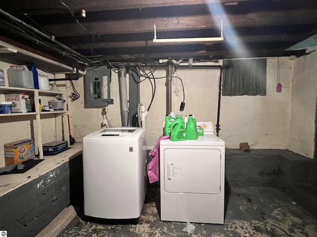 basement featuring separate washer and dryer and electric panel