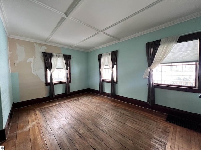 spare room with hardwood / wood-style floors, plenty of natural light, ornamental molding, and coffered ceiling