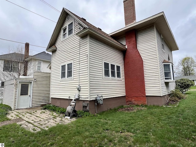 rear view of property featuring a yard