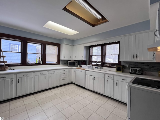 kitchen featuring stove, white cabinets, tasteful backsplash, sink, and dishwasher