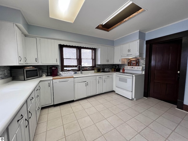 kitchen featuring white cabinetry, sink, backsplash, white appliances, and light tile patterned flooring