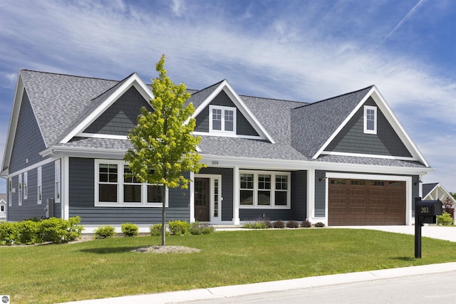 craftsman-style house featuring a front lawn and a garage