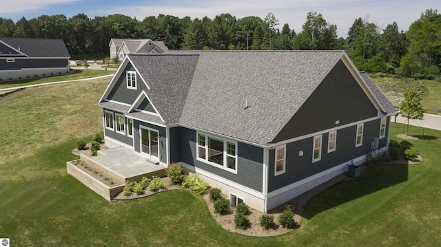 rear view of property featuring a lawn