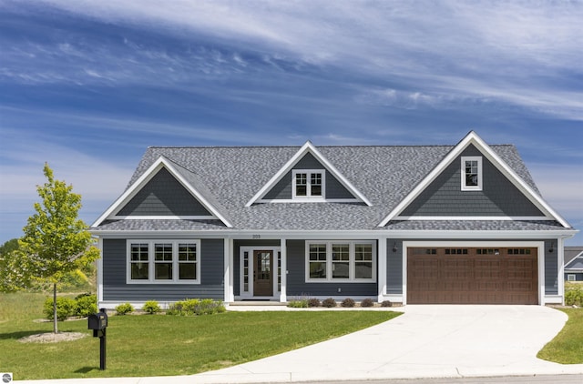 view of front of house with a front lawn and a garage