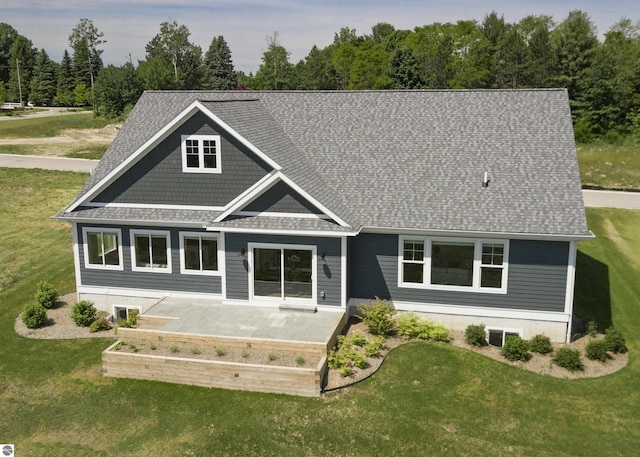 rear view of property featuring a lawn and a patio