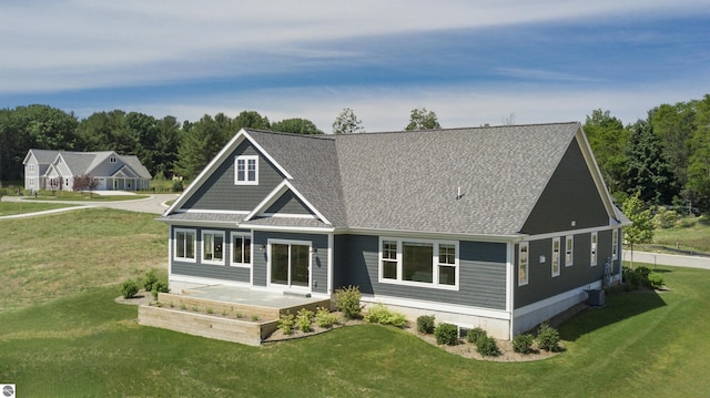 back of property featuring a lawn and a patio area