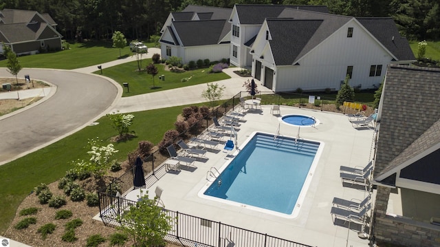 view of pool with a yard and a patio