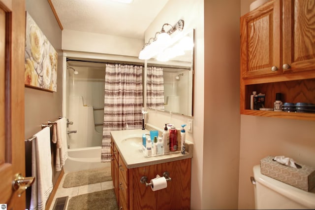 full bathroom featuring tile patterned floors, vanity, toilet, and shower / tub combo