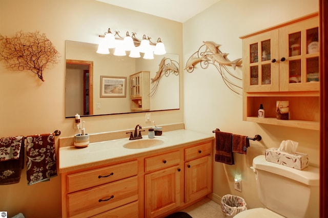 bathroom with tile patterned flooring, vanity, and toilet