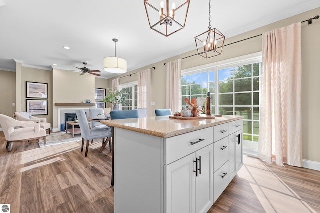 kitchen with light wood-type flooring, pendant lighting, and a center island