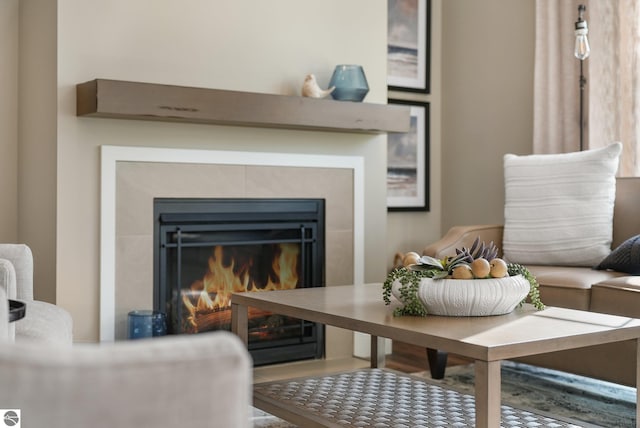 living area with a tile fireplace