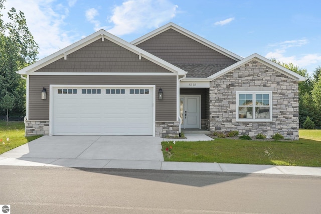 craftsman house with a front lawn and a garage