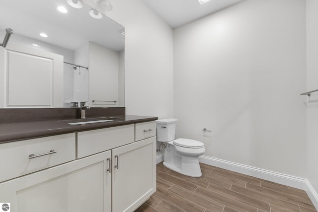 bathroom featuring a shower, toilet, and vanity