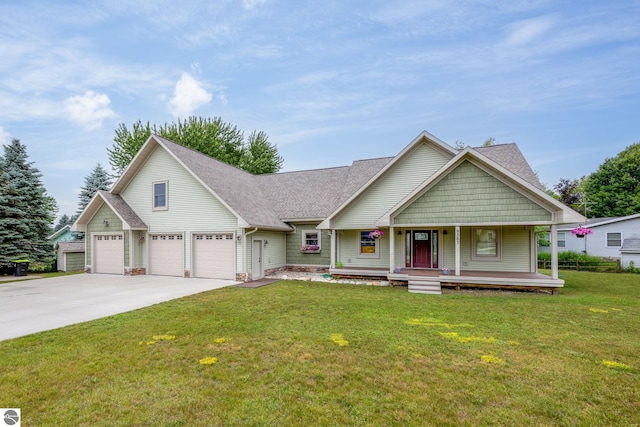 view of front of house with a porch, a garage, and a front lawn