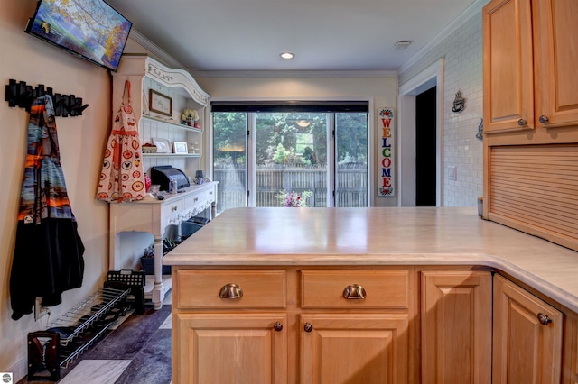 kitchen featuring kitchen peninsula and crown molding