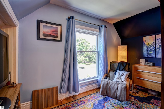 sitting room with hardwood / wood-style floors and vaulted ceiling