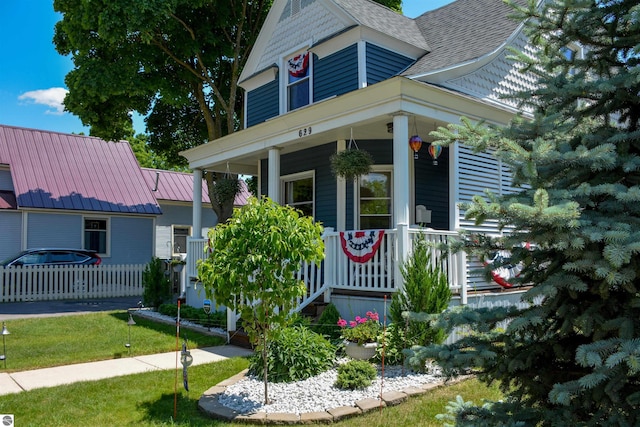 view of front facade with a front lawn and a porch