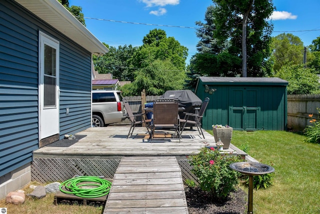 wooden terrace with a lawn and a storage shed