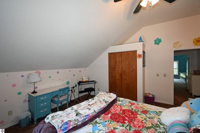 bedroom featuring ceiling fan, lofted ceiling, a closet, and a textured ceiling