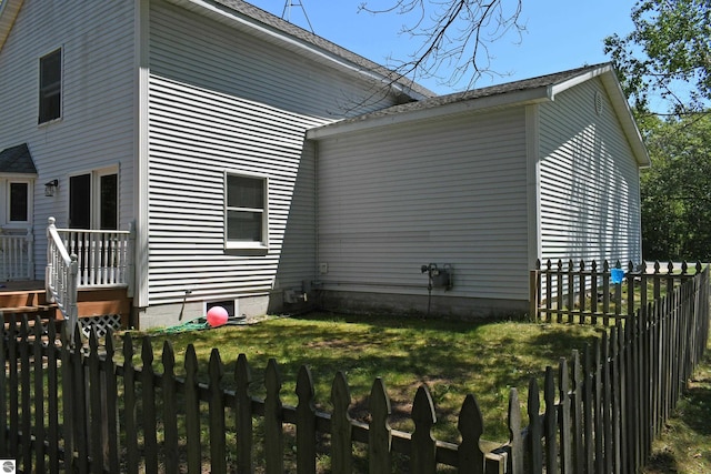 view of side of home with a yard