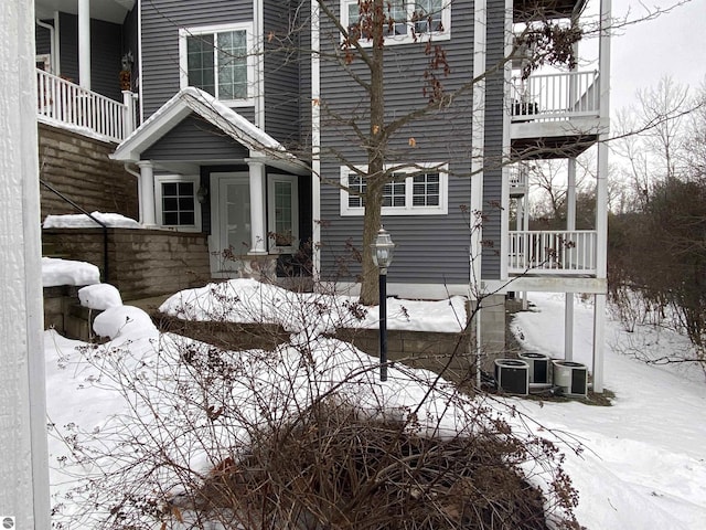 snow covered property featuring a balcony