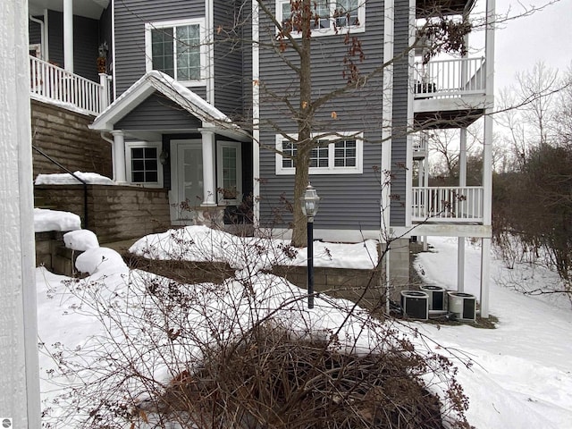 view of snow covered exterior featuring a balcony