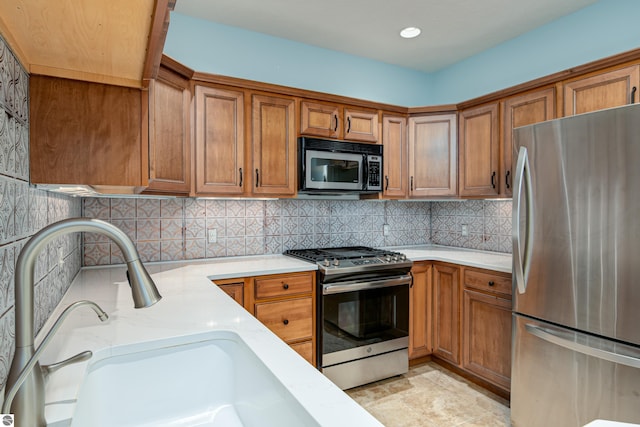 kitchen with appliances with stainless steel finishes and brown cabinets