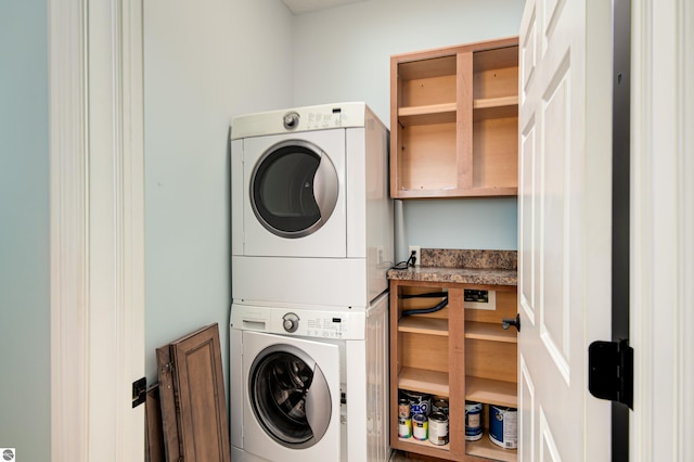 laundry area featuring laundry area and stacked washer and dryer