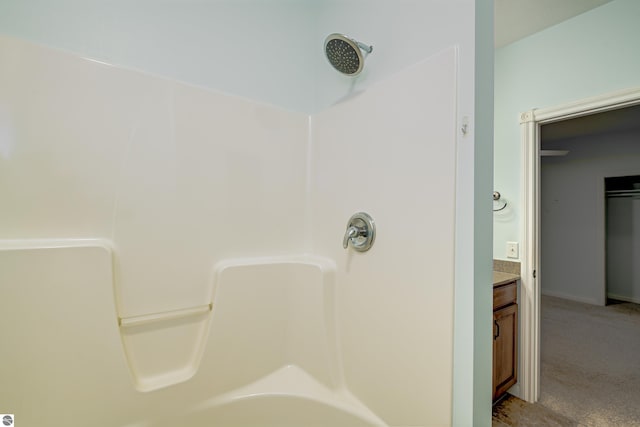 bathroom featuring a shower and vanity